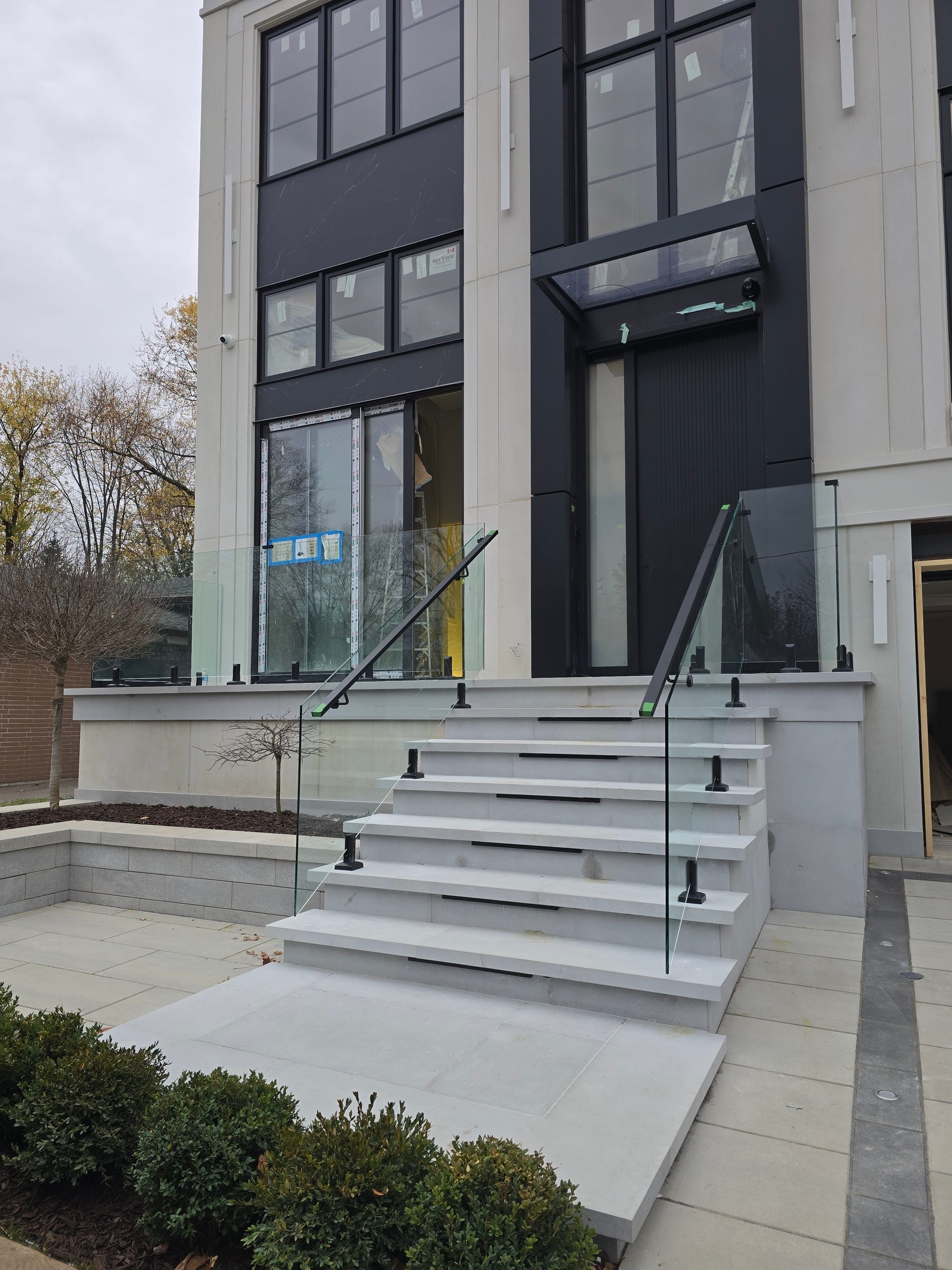 Exterior glass balcony railing with panoramic view — OBC-compliant glass railing installation by Built By Glass