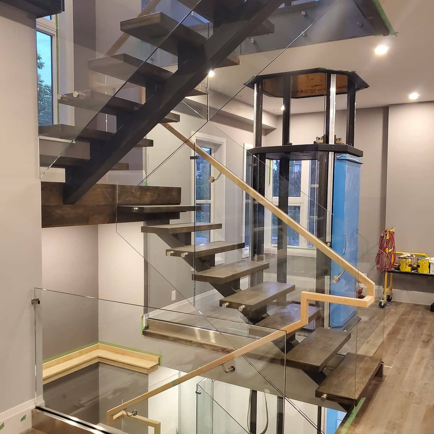 Frameless glass staircase railing with wood treads — Built By Glass