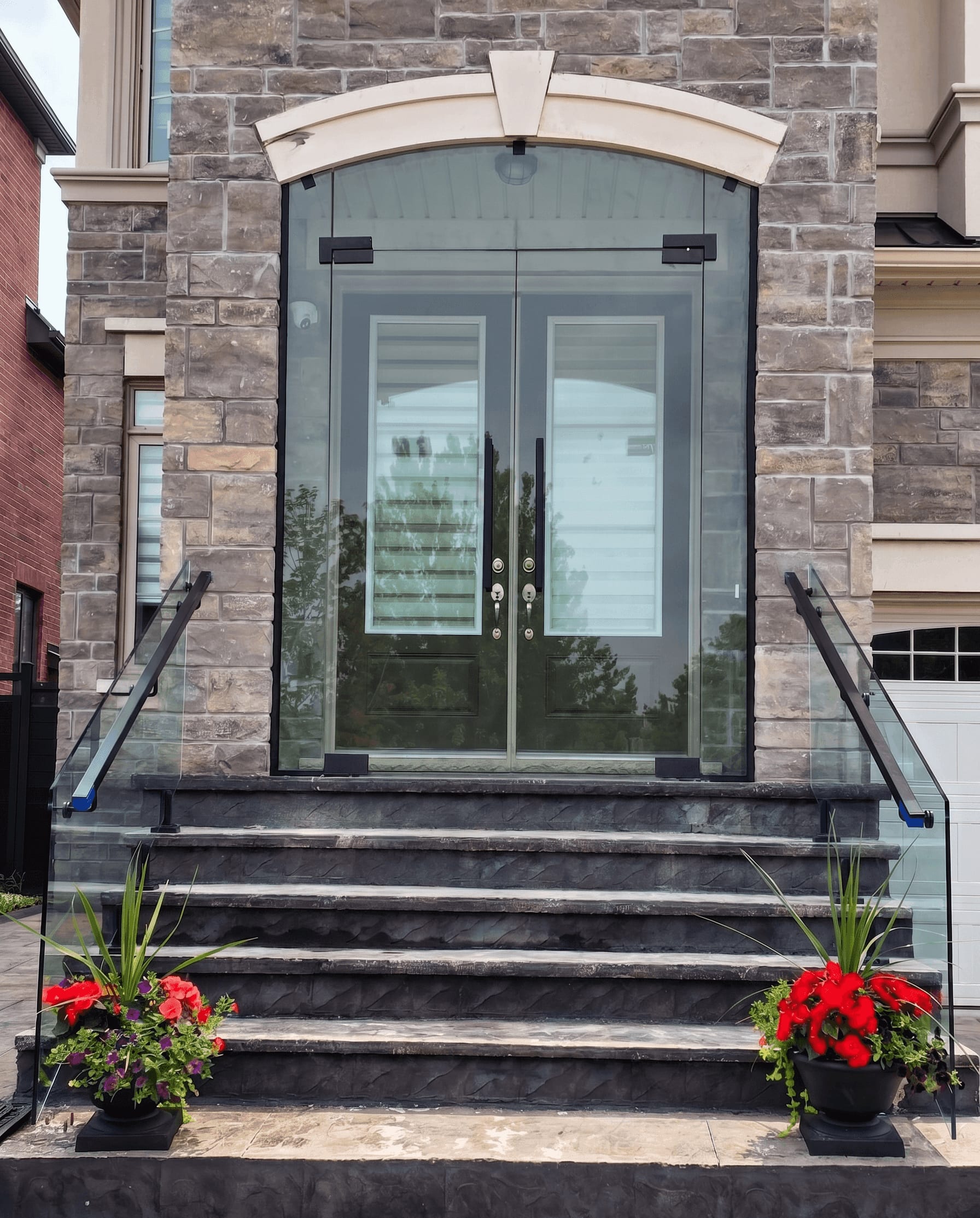 After: frameless glass porch enclosure installed at Markham front entrance — custom glass installation by Built By Glass