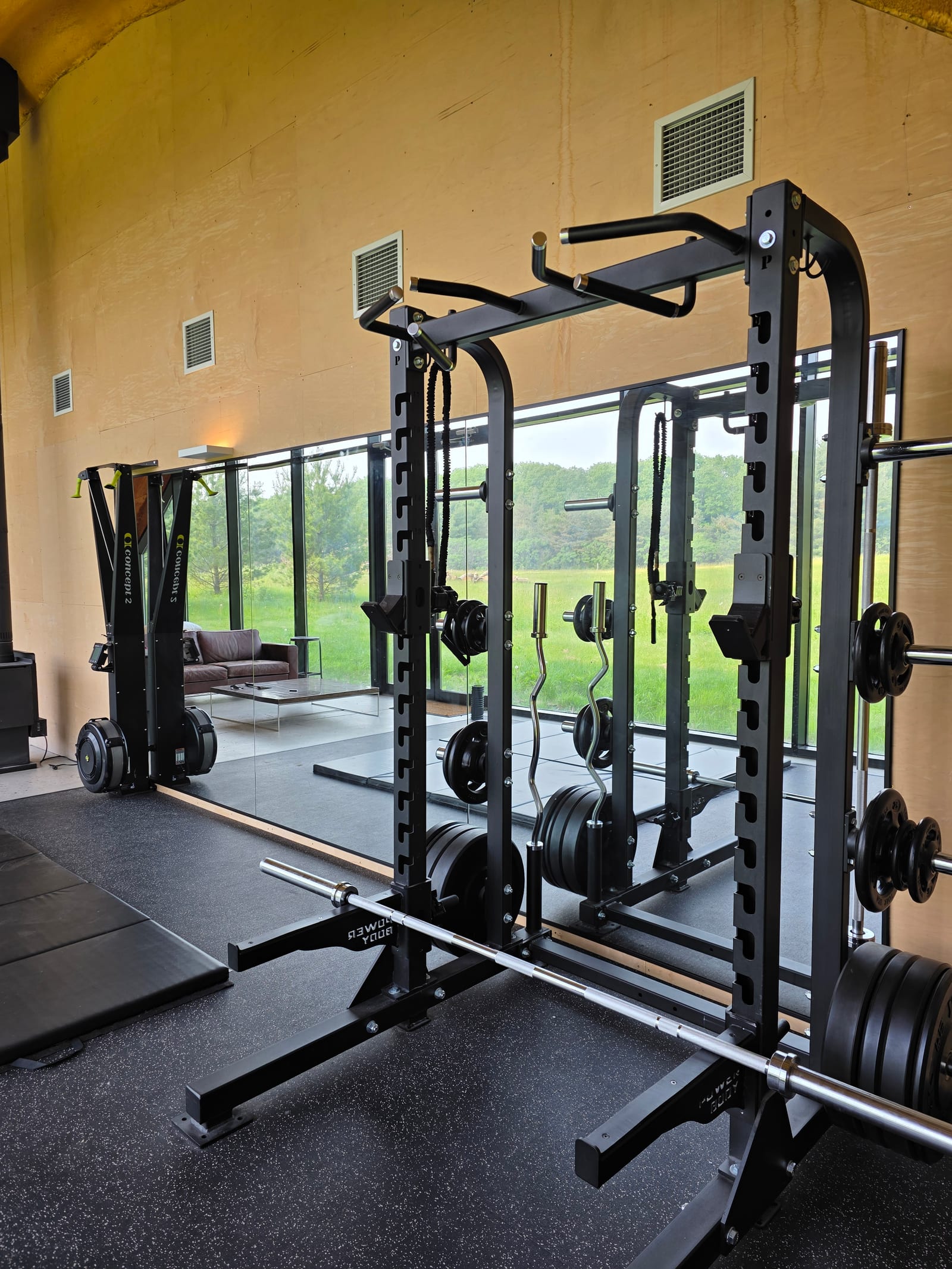 Home gym mirror wall behind a power rack — Built By Glass, Mississauga