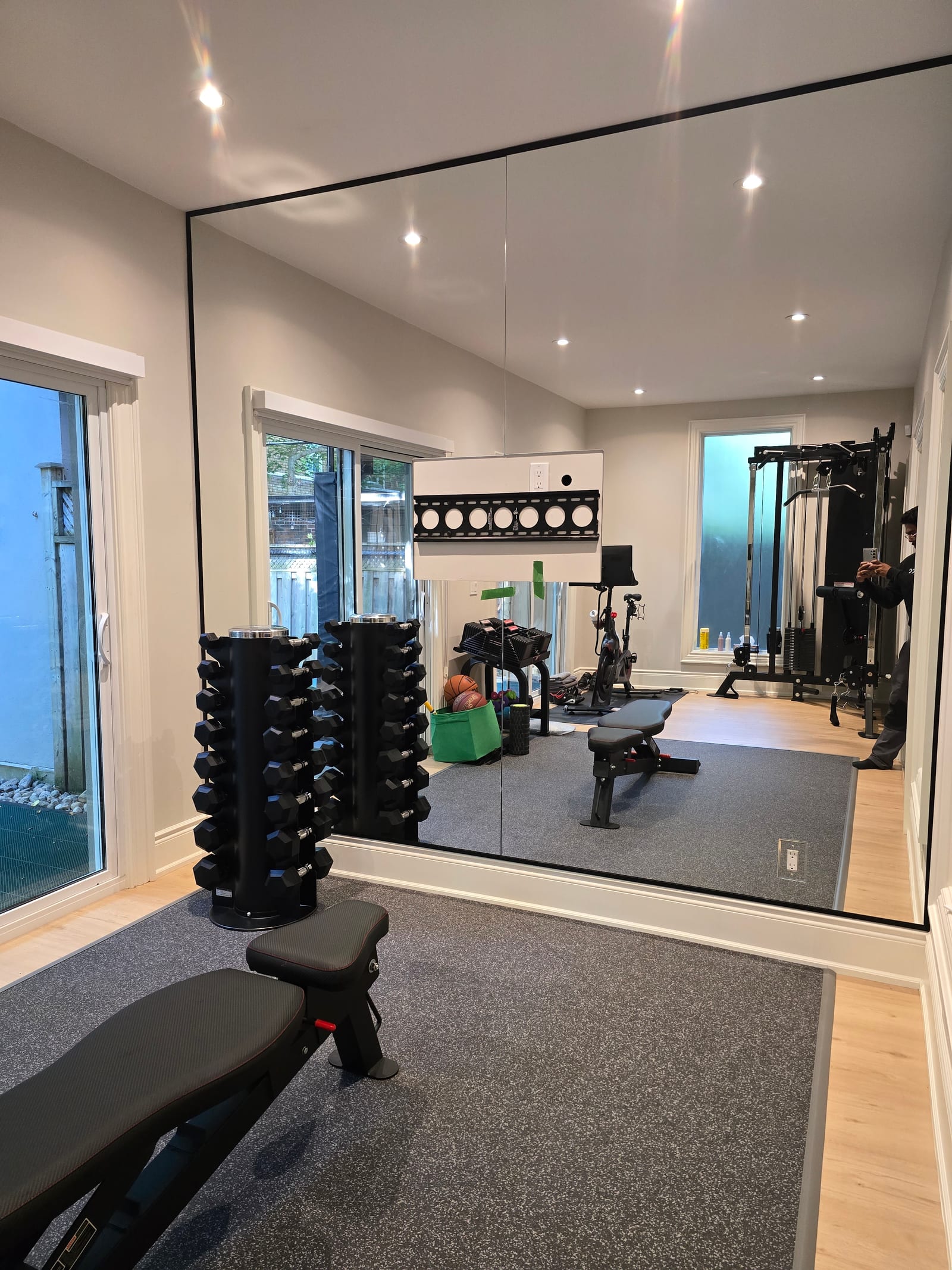 Home gym mirror wall with a waterfront view — Built By Glass GTA